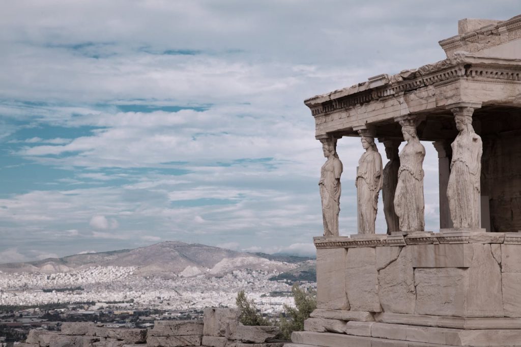 Temple dedicated to Athena atop the Acropolis in Athens. It has female statues holding up the roof of the temple. 