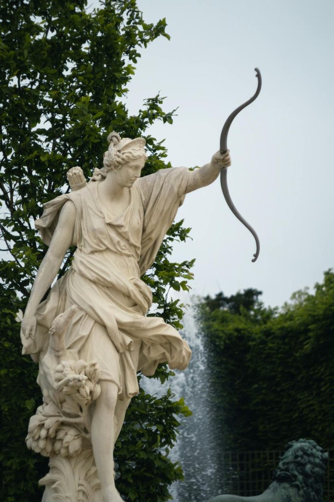 A state of Artemis. She is holding a bow in one hand. 